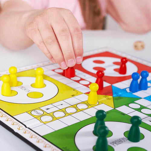  Close up of childs hand moving a counter around the board 