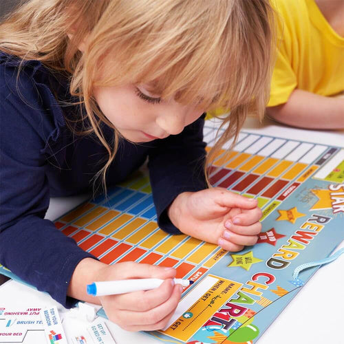  Child writing on magnetic reward chart with wipeable pen 