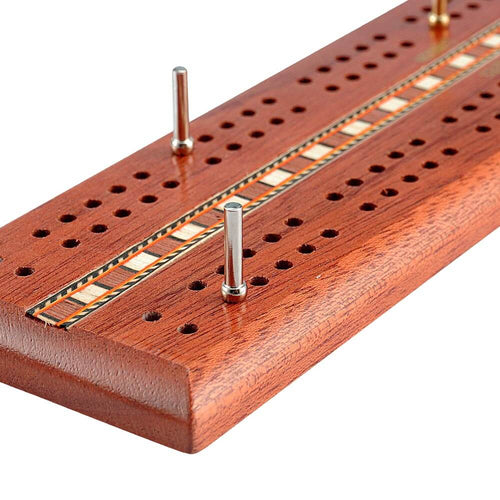  Close up of mahogany cribbage board with cards 