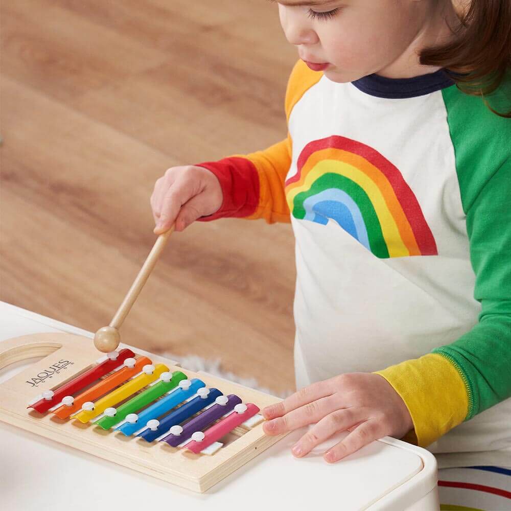 Child making music with colourful xylophone