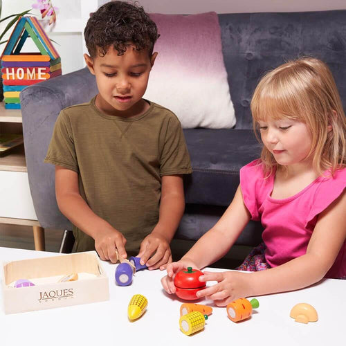 Children cutting wooden fruit and vegetables 