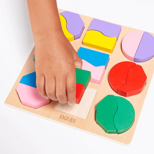 Childs hand plaacing colourful square shape in shape sorting board
