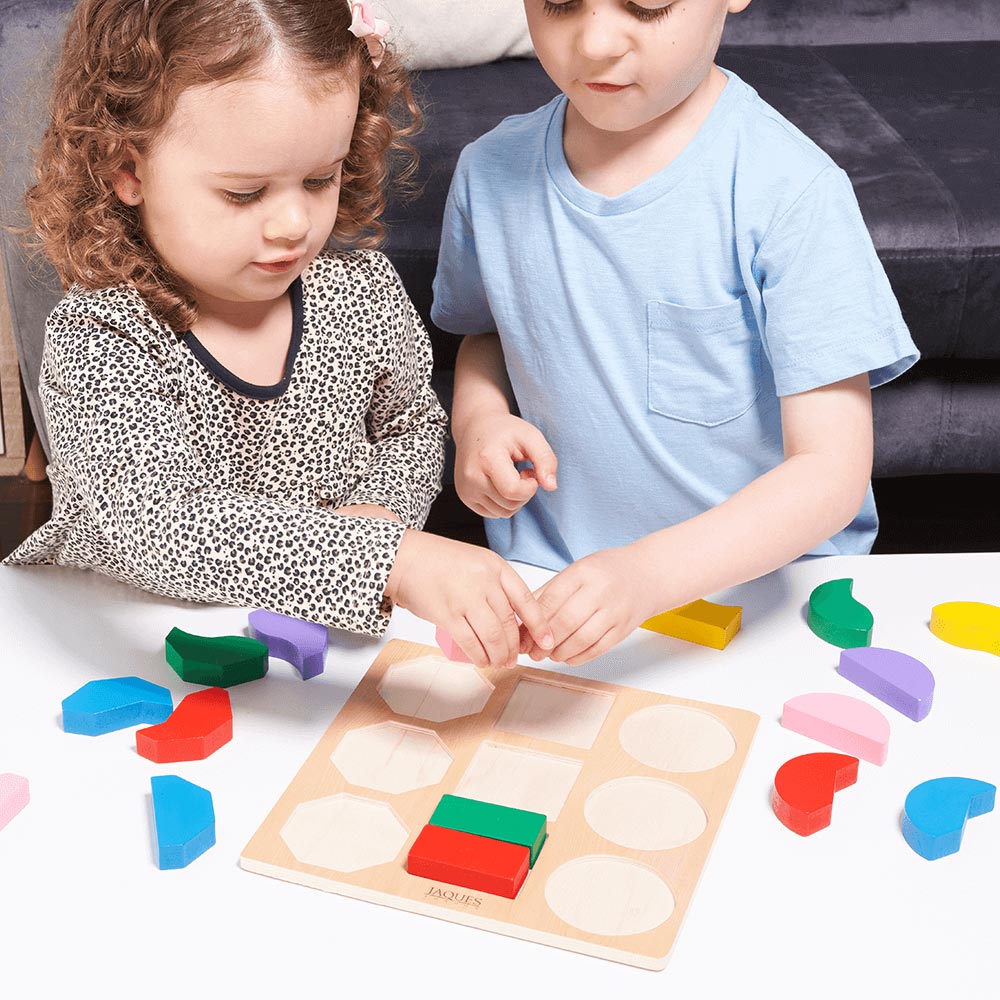  Children placing shape iin shape sorting board