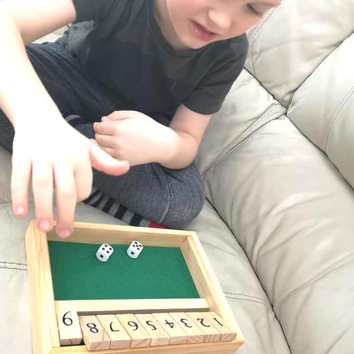  Child playing shut the box 9s