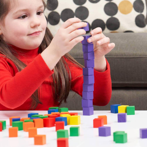  Child building purple tower with small building blocks