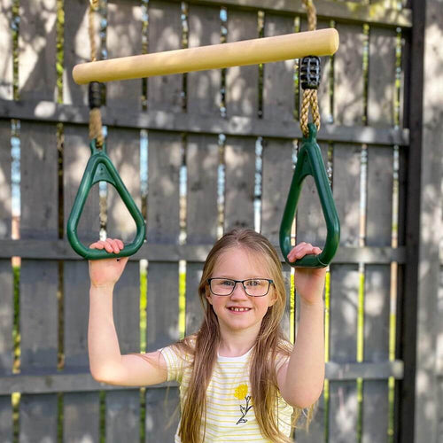  Child holding handles of trapeze bar