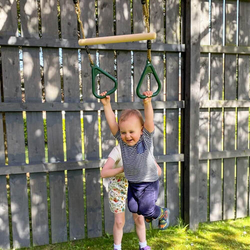  Child swinging on trapeze bar 