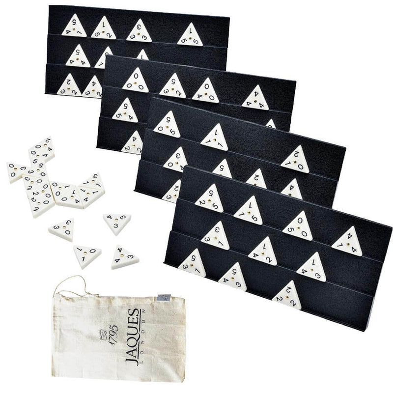 A classic family game triangle dominoes . Dominoes arranged on holders with bag and other dominoes placed on the table surface