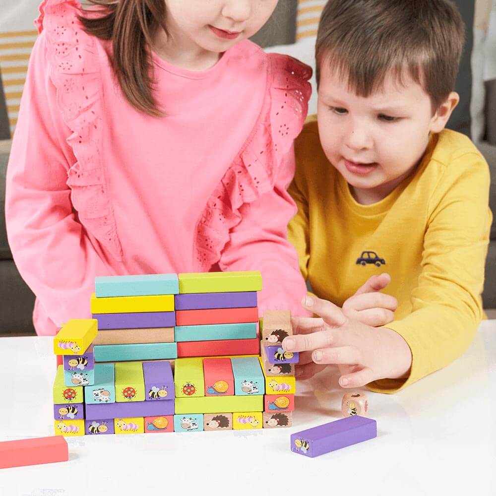  Boy and girl building a chair out of tumble tower blocks