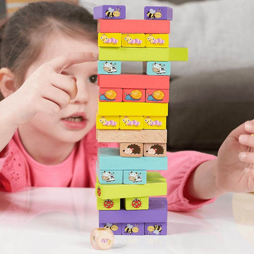  Girl focused on pushing block out of tumble tower 