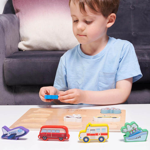  Boy sorting vehicle pieces on board