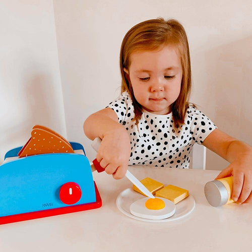  Child playing with wooden breakfast set 