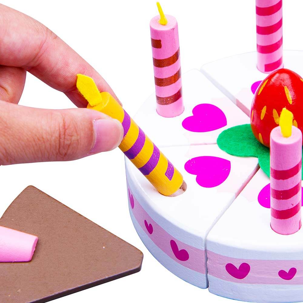  Wooden party cake for kids - hand pulling out pretend candle 