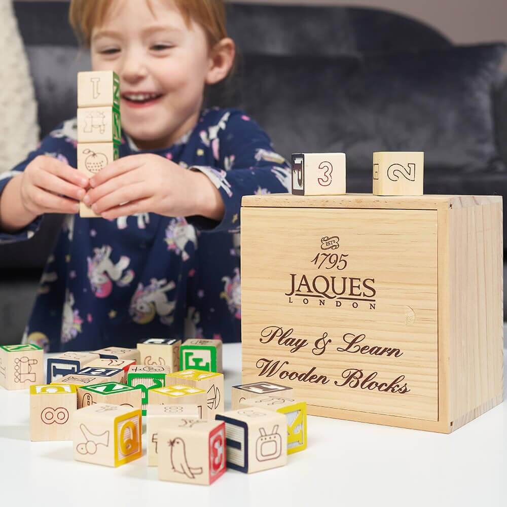  Educational wooden blocks next to storage box 