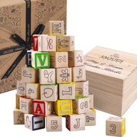 Educational blocks next to wooden storage box and Jaques packaging [lifestyle]