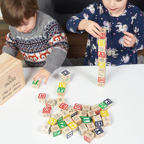  Children building towers with educational alphabet and number blocks