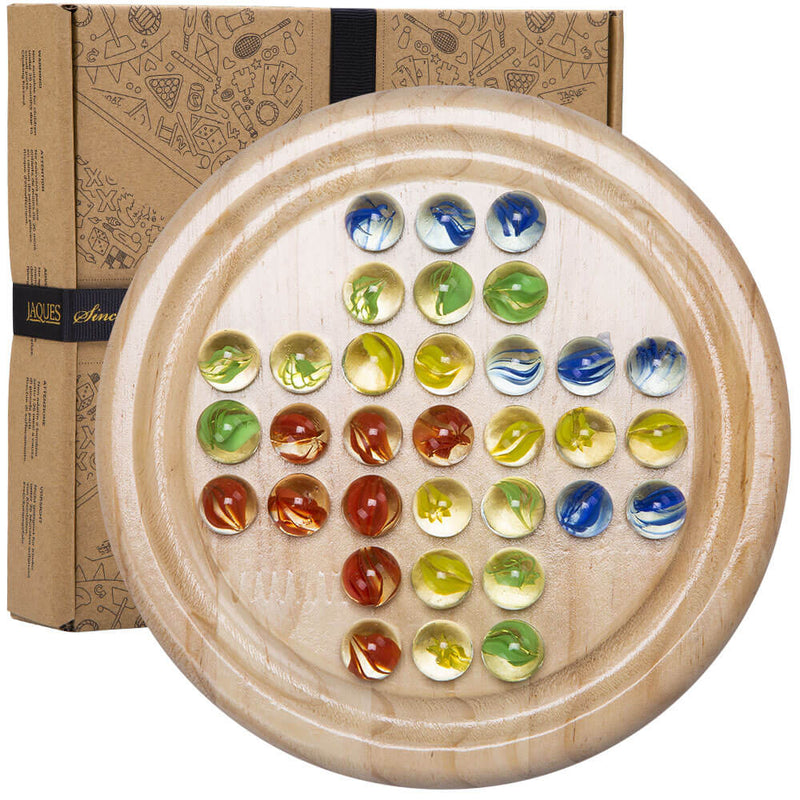 Family wooden solitaire game with glass marbles - overhead shot of board and marbles ready to play